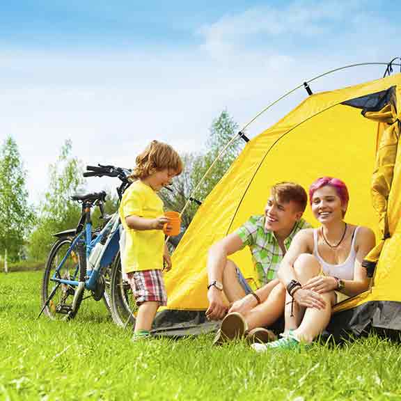 family sitting in a tent square